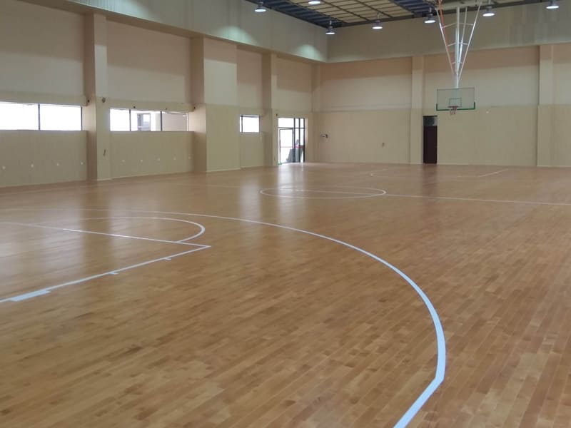 What kind of floor material is usually used for a basketball court