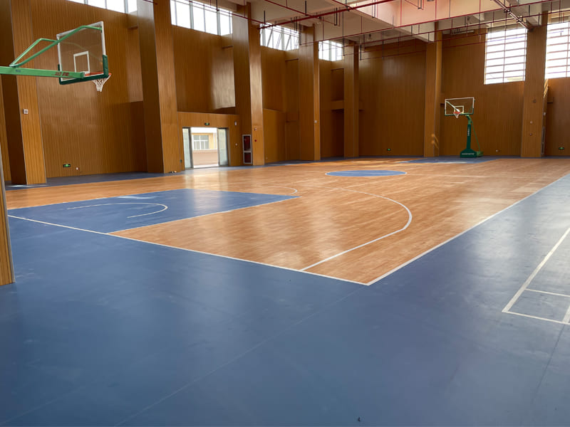 What kind of floor material is usually used for a basketball court